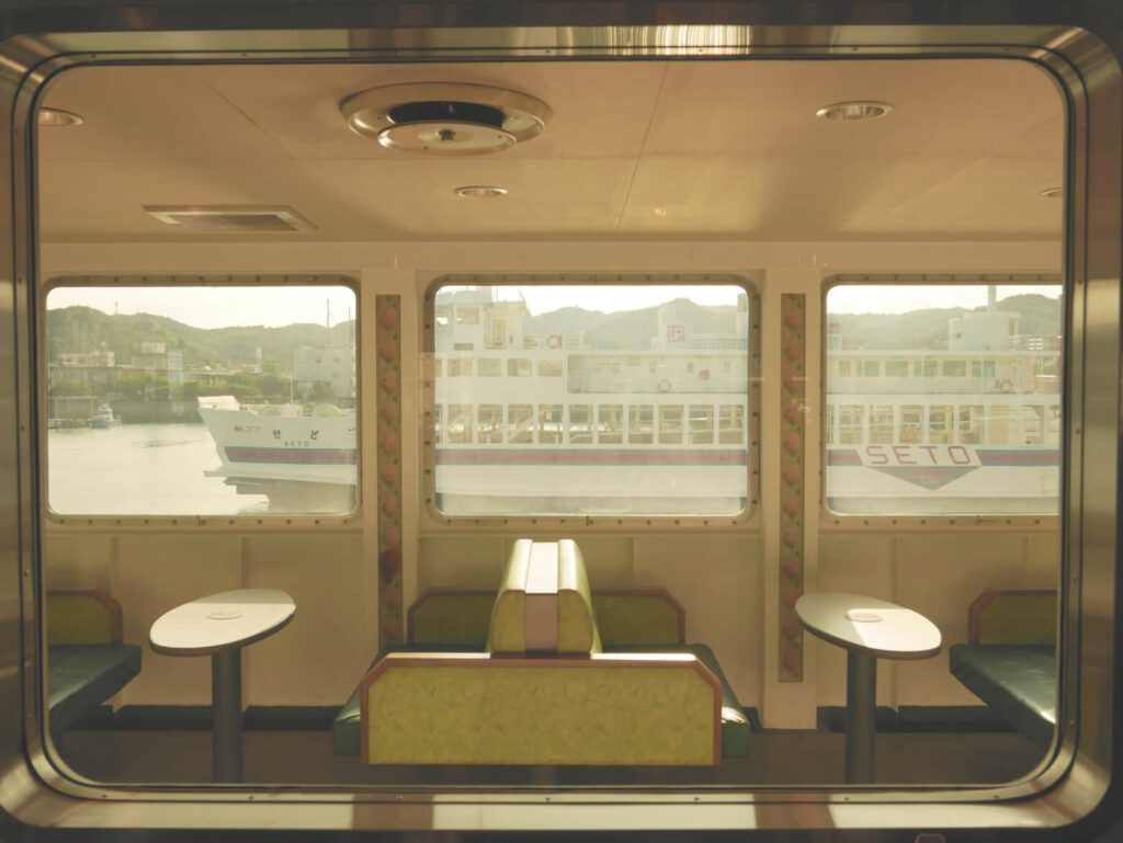 Вид в окно корабля со столами и скамейками